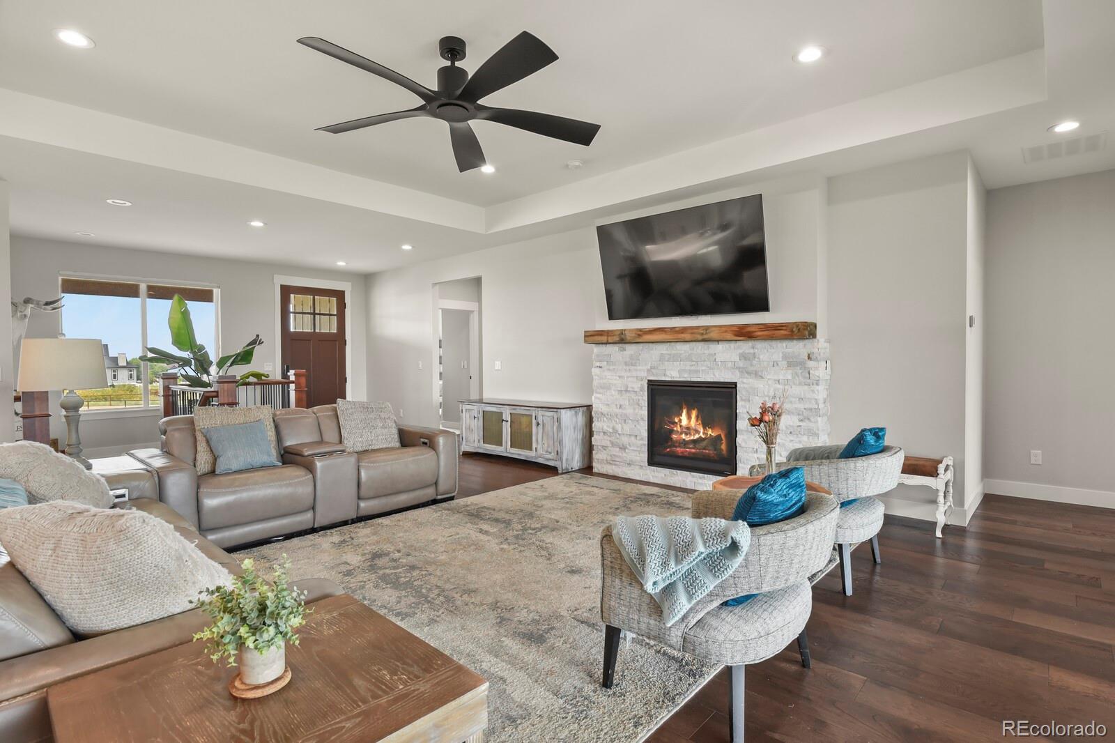 11617 Harpenden Court Fort Lupton, CO 80621 - Photo 11 of 50 a living room with furniture and a fireplace