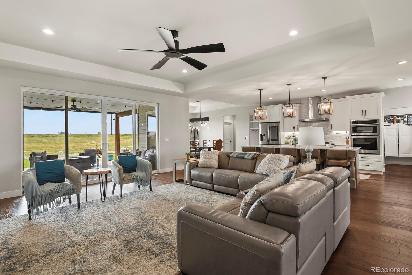 11617 Harpenden Court Fort Lupton, CO 80621 - Photo 12 of 50 a living room with furniture and a large window
