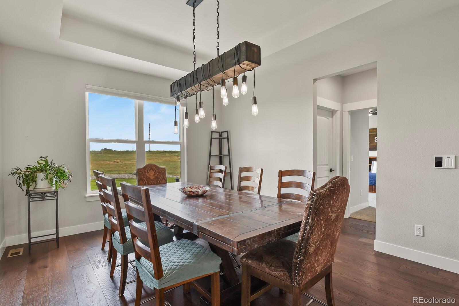 11617 Harpenden Court Fort Lupton, CO 80621 - Photo 13 of 50 a view of a dining room with furniture window and wooden floor