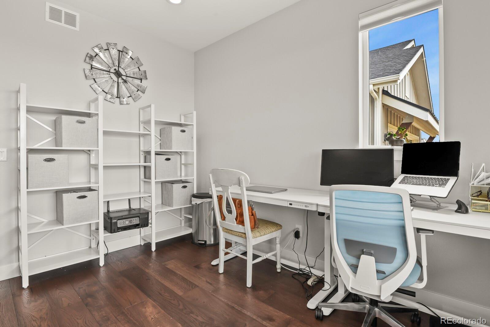 11617 Harpenden Court Fort Lupton, CO 80621 - Photo 14 of 50 a view of a workspace with furniture and wooden floor