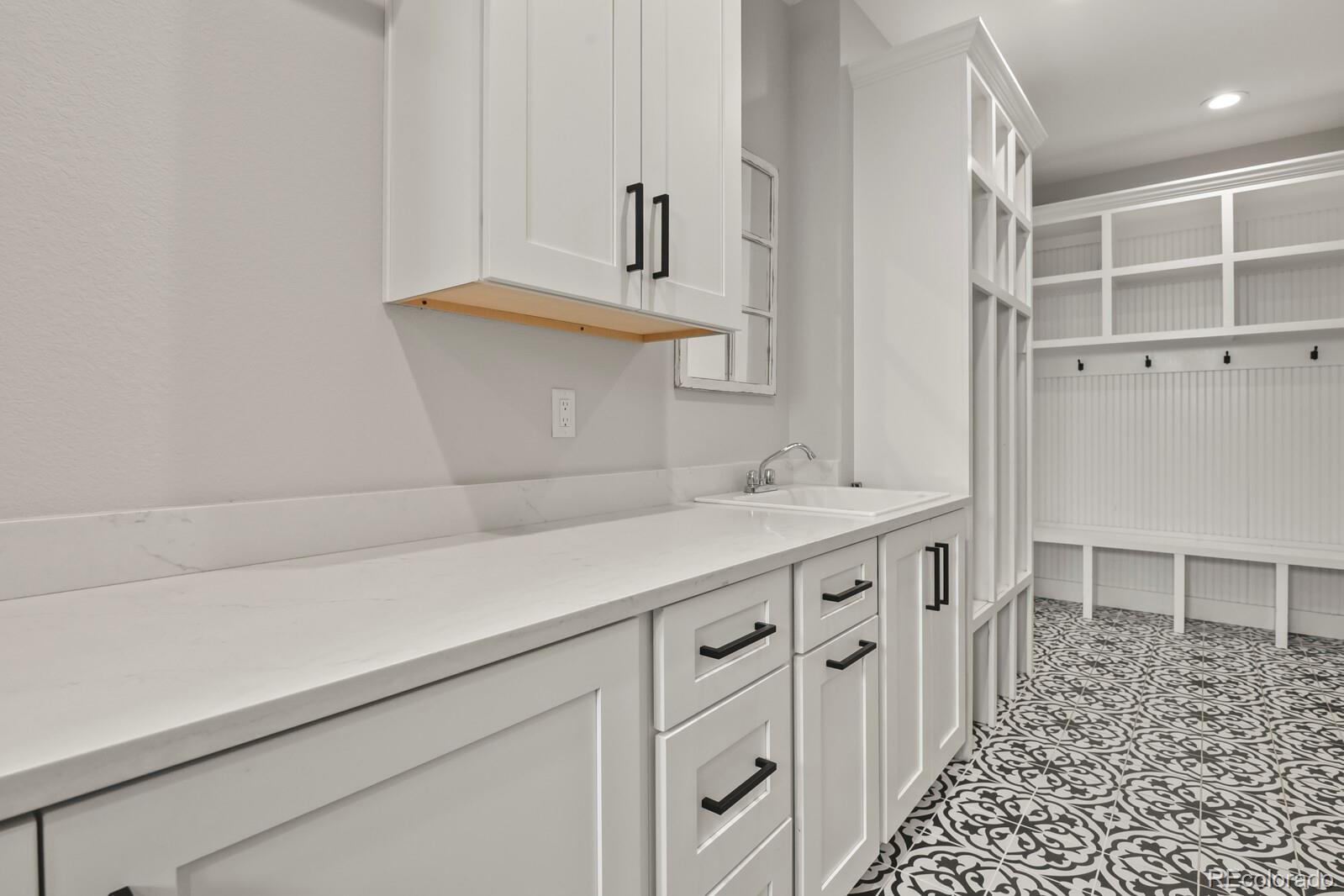 11617 Harpenden Court Fort Lupton, CO 80621 - Photo 18 of 50 a kitchen with a sink and cabinets