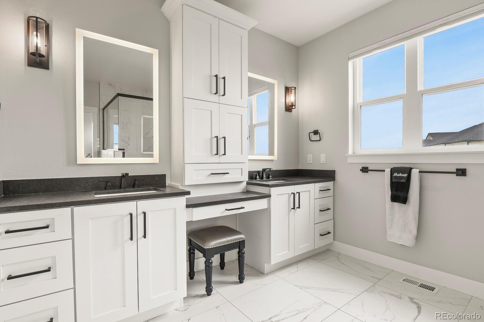 11617 Harpenden Court Fort Lupton, CO 80621 - Photo 24 of 50 a kitchen with granite countertop white cabinets and white appliances