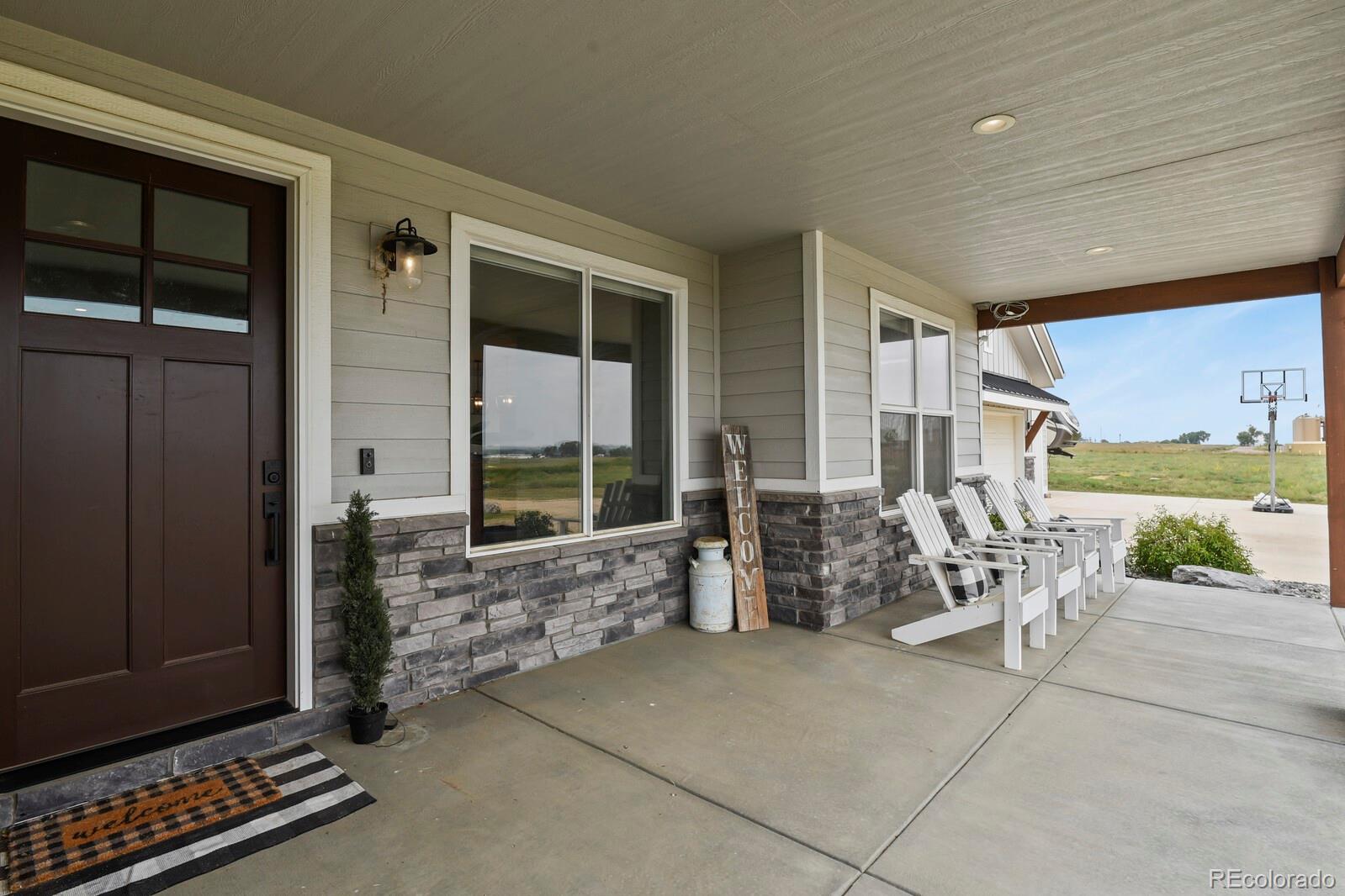11617 Harpenden Court Fort Lupton, CO 80621 - Photo 32 of 50 a building outdoor space with patio furniture and potted plants