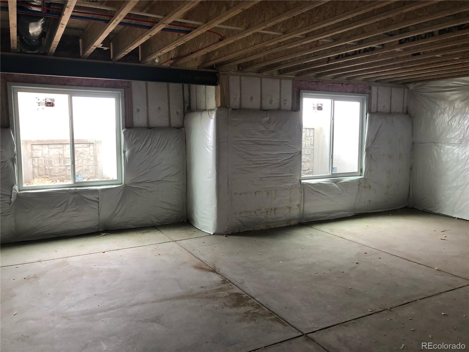 11617 Harpenden Court Fort Lupton, CO 80621 - Photo 41 of 50 an empty room with windows