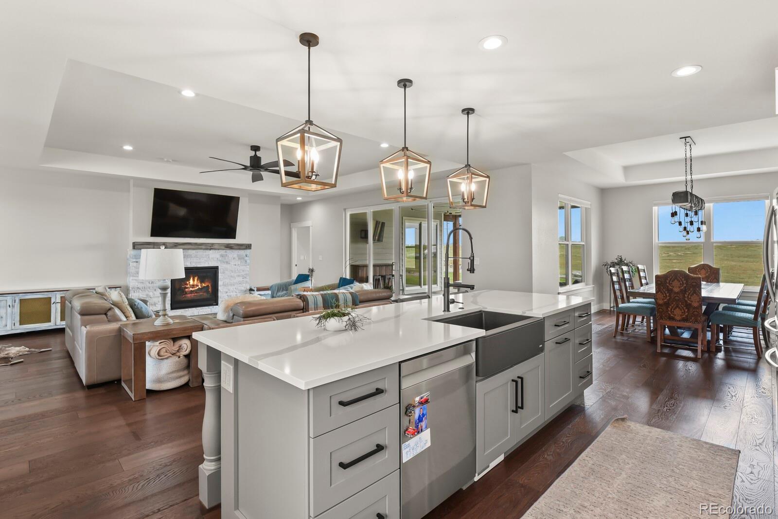 11617 Harpenden Court Fort Lupton, CO 80621 - Photo 7 of 50 a open kitchen with a sink stove and living room view