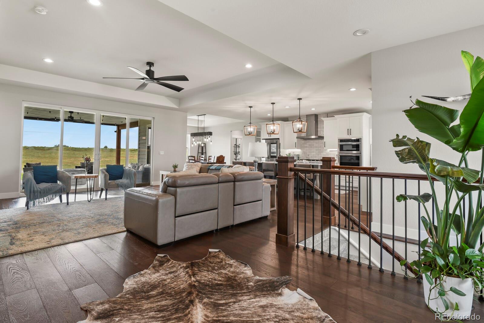 11617 Harpenden Court Fort Lupton, CO 80621 - Photo 10 of 50 a living room with furniture kitchen view and a wooden floor