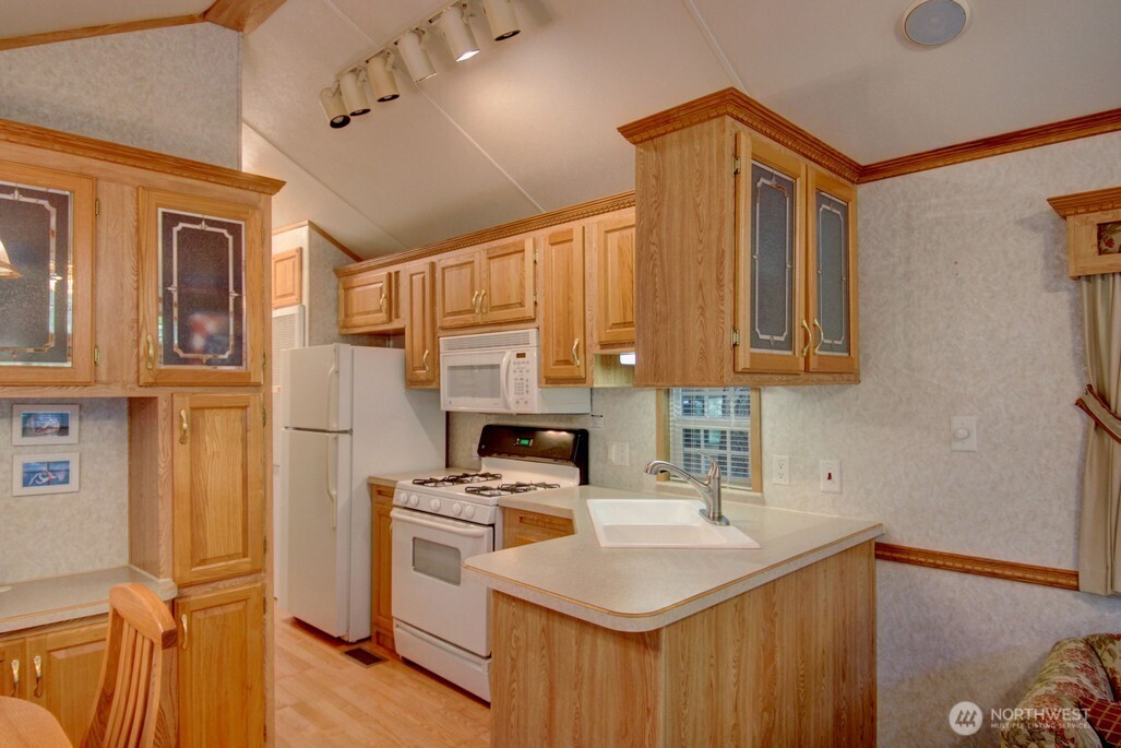134 Drial Loop Maple Falls, WA 98266 - Photo 5 of 36 a kitchen with a sink a stove and cabinets