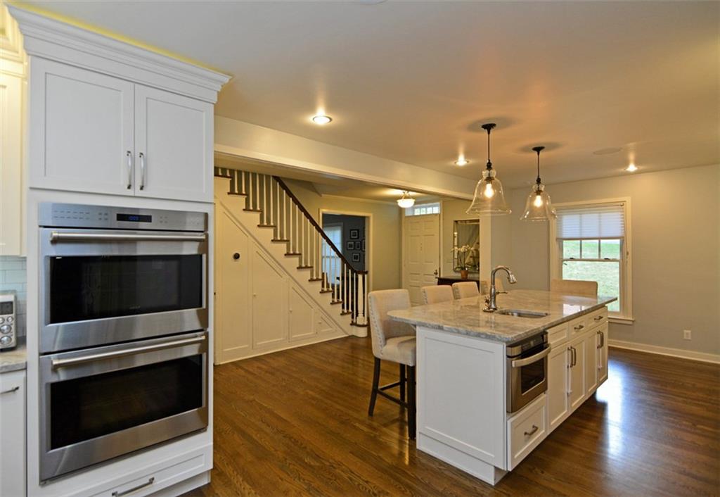 3 Edgewood Road Pittsburgh, PA 15215 - Photo 6 of 18 The reverse view of the kitchen showcases the built-in double oven and classic hardwood flooring.