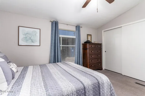 a bedroom with a bed and a closet