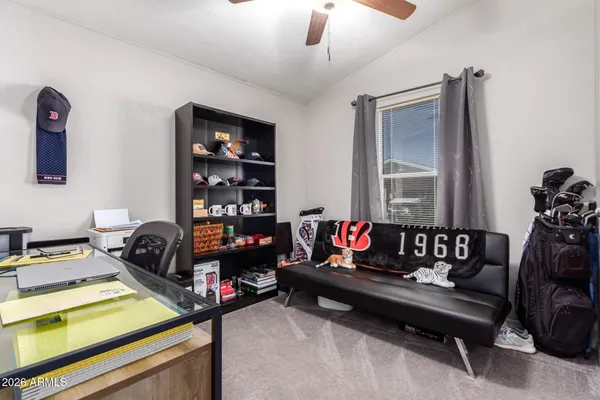 a living room with furniture a flat screen tv and a chandelier