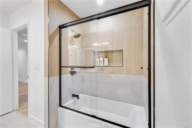a bathroom with a glass shower door