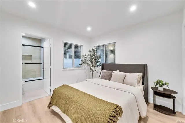 a bedroom with a large bed and a chandelier