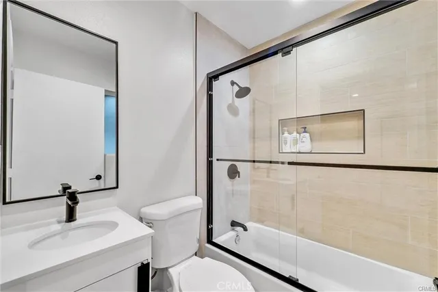 a bathroom with a sink mirror toilet and bathtub
