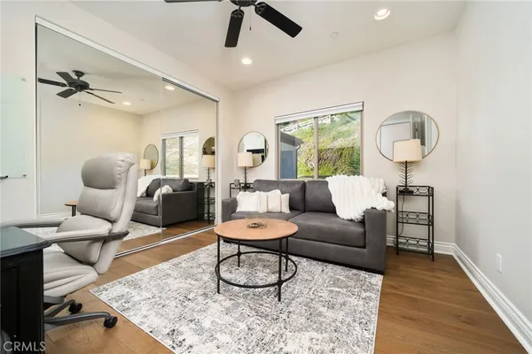 a view of a balcony with couches and wooden floor