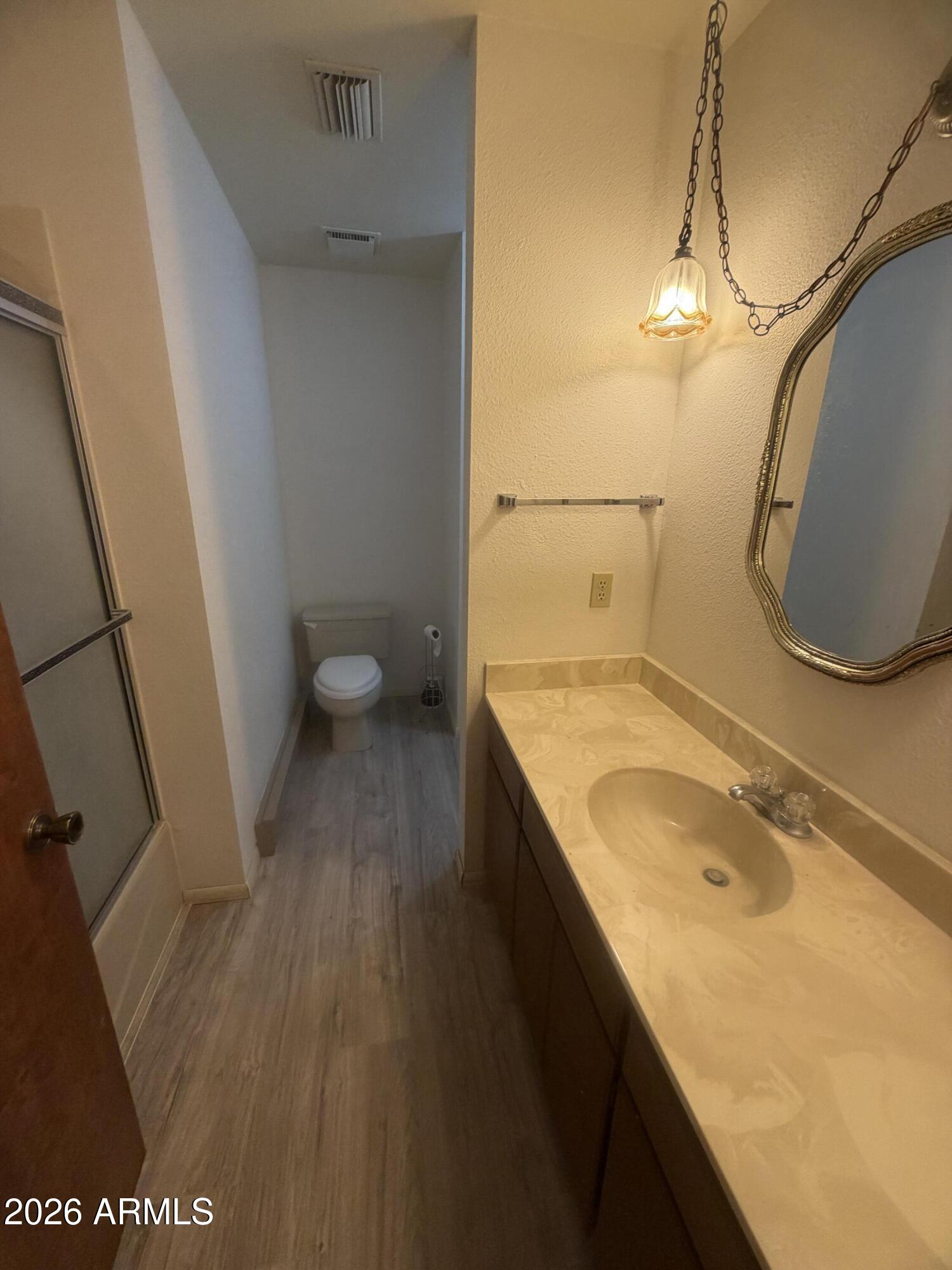 3255 East Rimrock Drive Rimrock, AZ 86335 - Photo 15 of 18 a bathroom with a granite countertop sink a toilet and a mirror
