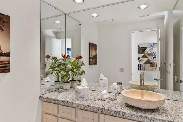 a bedroom with a bed and painting on the wall