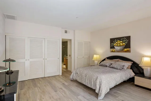 a bathroom with a granite countertop tub sink shower and mirror
