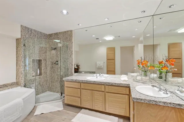 a bathroom with a granite countertop sink a toilet and shower