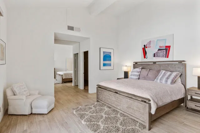 a spacious bedroom with a bed and a couch