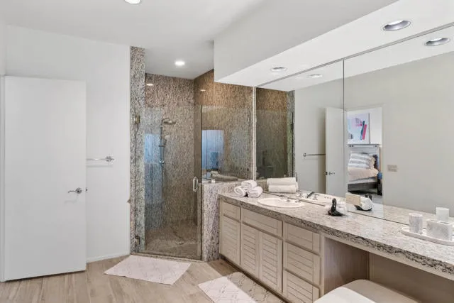 a bed room with a bed and painting on the wall