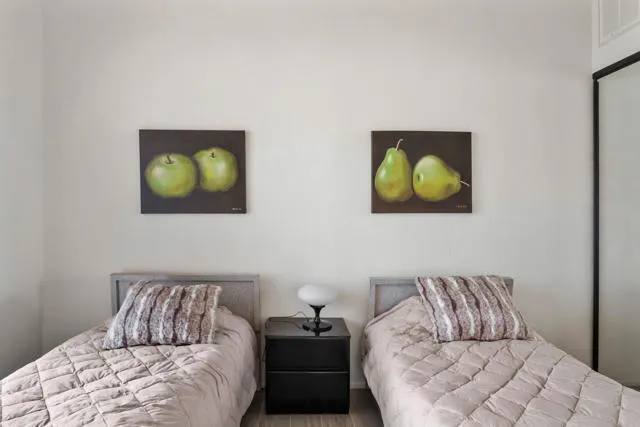 a bathroom with a granite countertop sink a mirror and shower