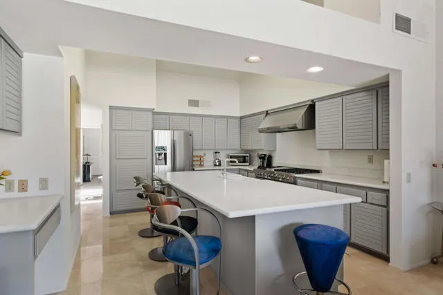 a kitchen with a sink a stove a refrigerator and cabinets