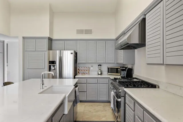a kitchen with a sink stove and refrigerator