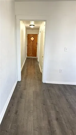 a view of a kitchen with wooden floor and electronic appliances