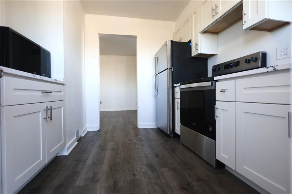 2811 Brownsville Road, Unit 4 Brentwood, PA 15227 - Photo 3 of 14 a view of a kitchen with wooden floor and electronic appliances