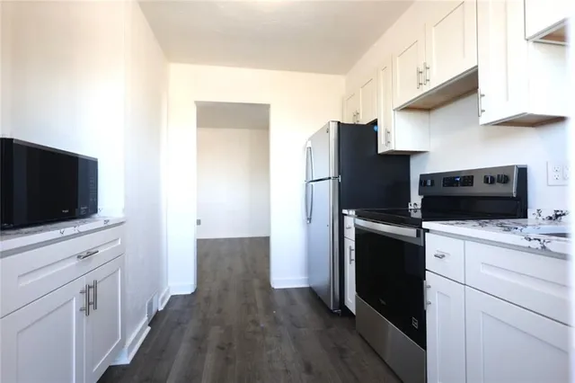 a kitchen with a stove a sink and a microwave