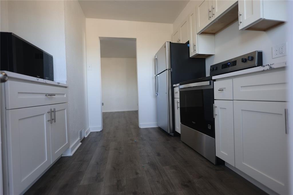 2811 Brownsville Road, Unit 4 Brentwood, PA 15227 - Photo 7 of 14 a kitchen with a refrigerator and a stove top oven