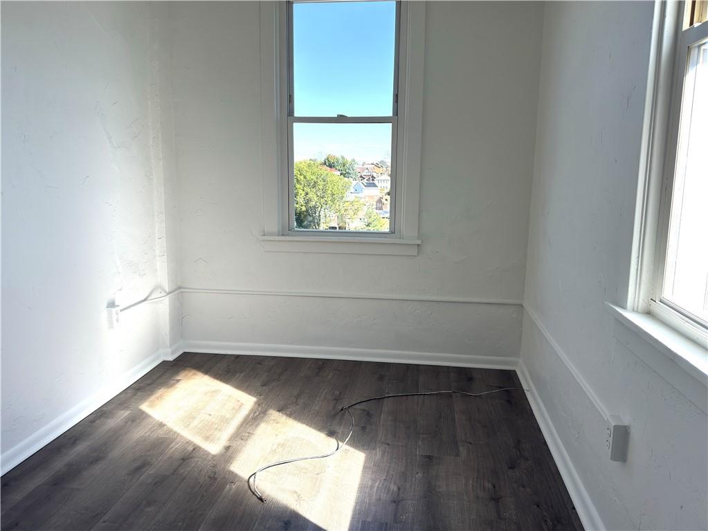 2811 Brownsville Road, Unit 4 Brentwood, PA 15227 - Photo 9 of 14 an empty room with wooden floor and windows