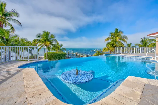 a view of a swimming pool with a table and chairs