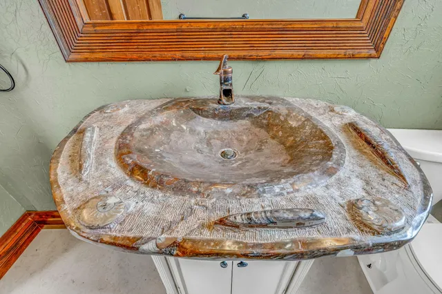 a living room with furniture and a large window with garden view