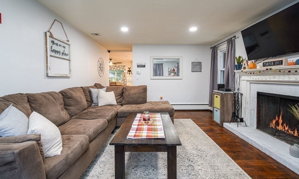 148 Glenoak Drive Springfield, MA 01129 - Photo 14 of 28 a living room with furniture a flat screen tv and a fireplace