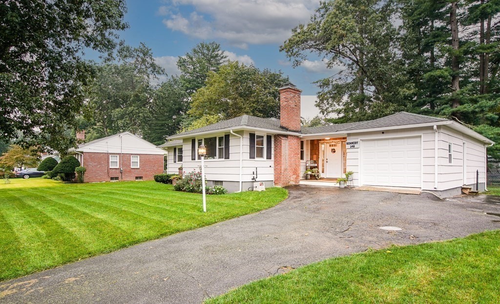 148 Glenoak Drive Springfield, MA 01129 - Photo 2 of 28 a front view of a house with a garden and trees