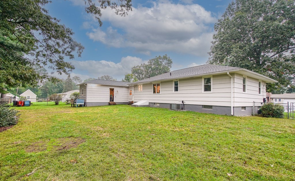 148 Glenoak Drive Springfield, MA 01129 - Photo 27 of 28 a front view of a house with a garden and deck