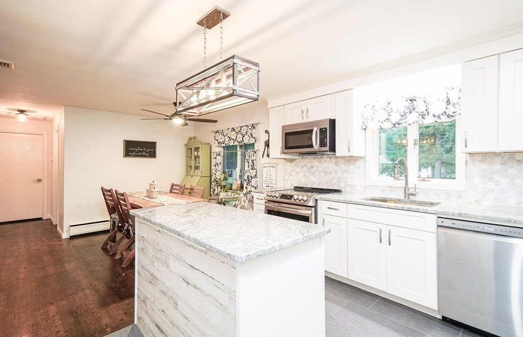148 Glenoak Drive Springfield, MA 01129 - Photo 8 of 28 a kitchen with granite countertop a sink stove and refrigerator