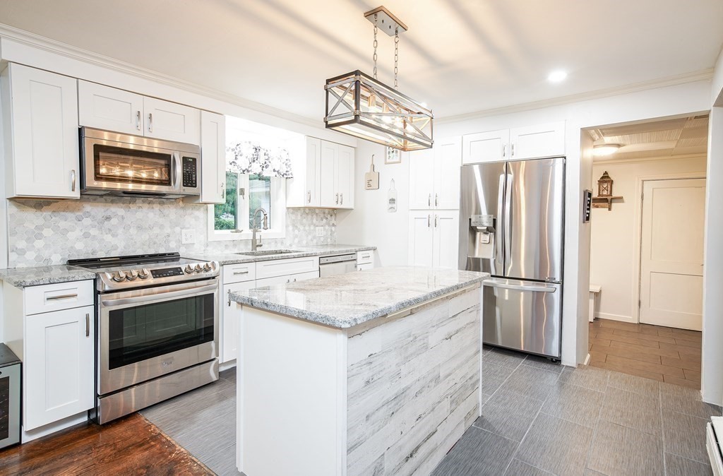 148 Glenoak Drive Springfield, MA 01129 - Photo 9 of 28 a kitchen with stainless steel appliances granite countertop a refrigerator stove a sink and a microwave