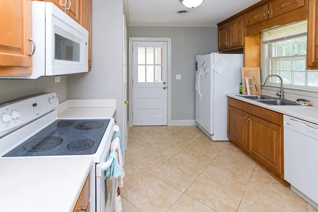 a kitchen with a sink a refrigerator and cabinets