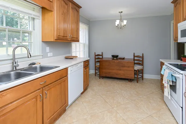 a kitchen with stainless steel appliances granite countertop a sink and cabinets