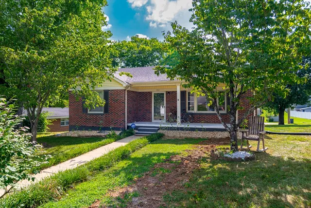 a view of a house with swimming pool and a yard