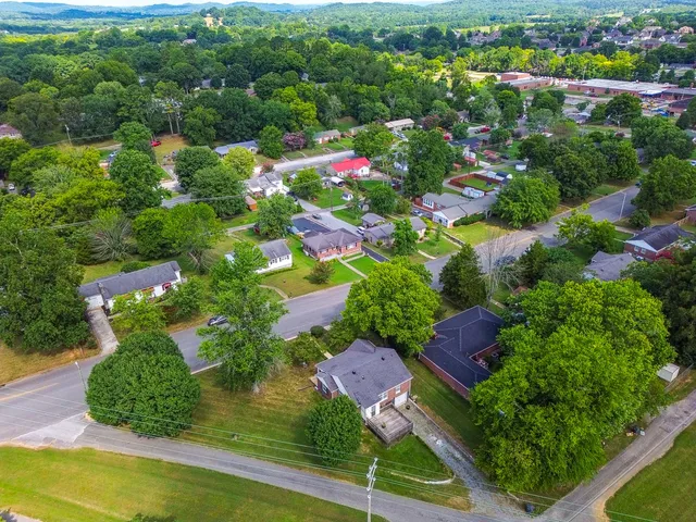 an aerial view of residential houses with outdoor space and street view