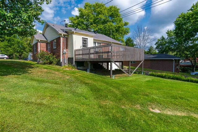 a view of a house with a backyard and a patio