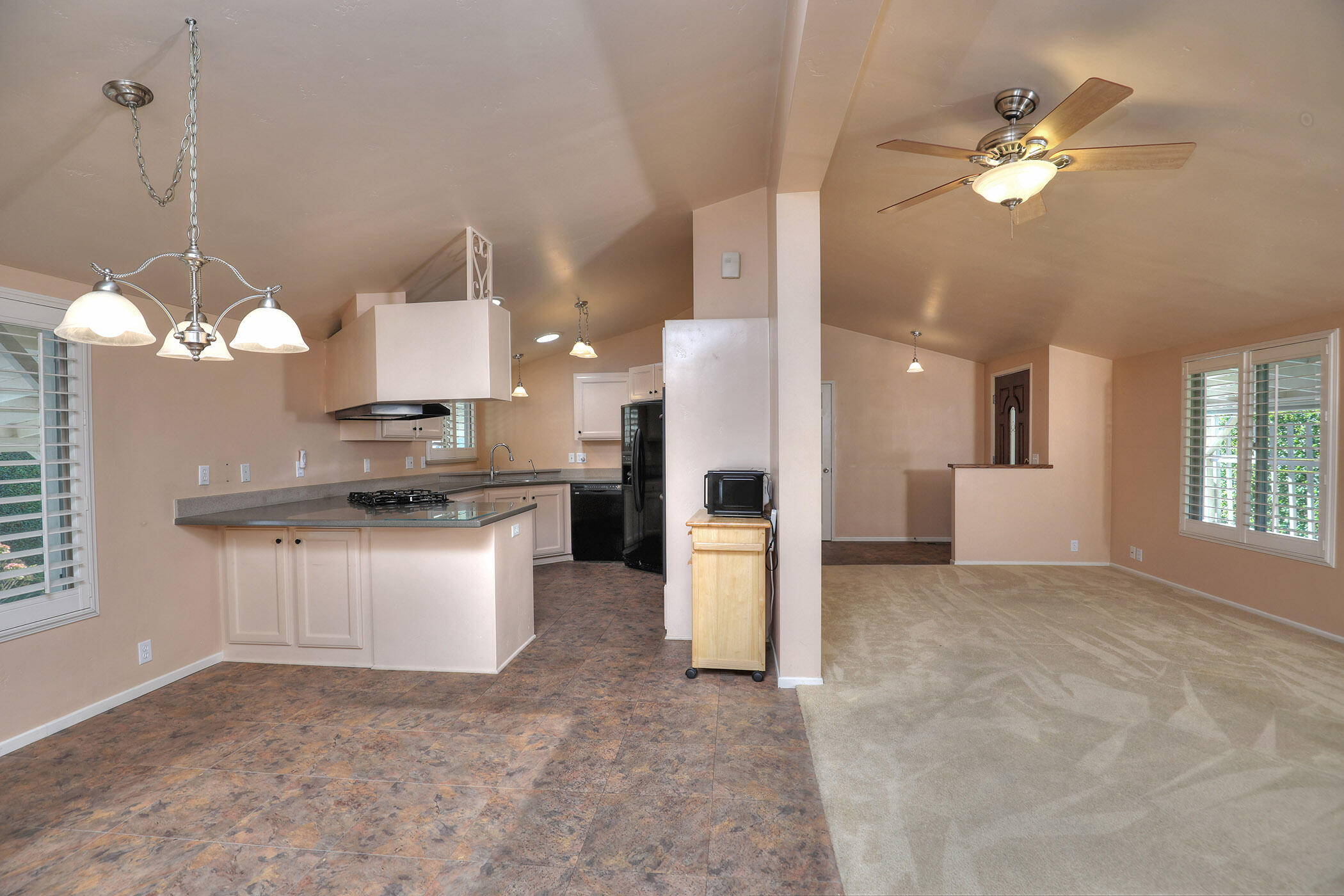 a view of kitchen with refrigerator and window