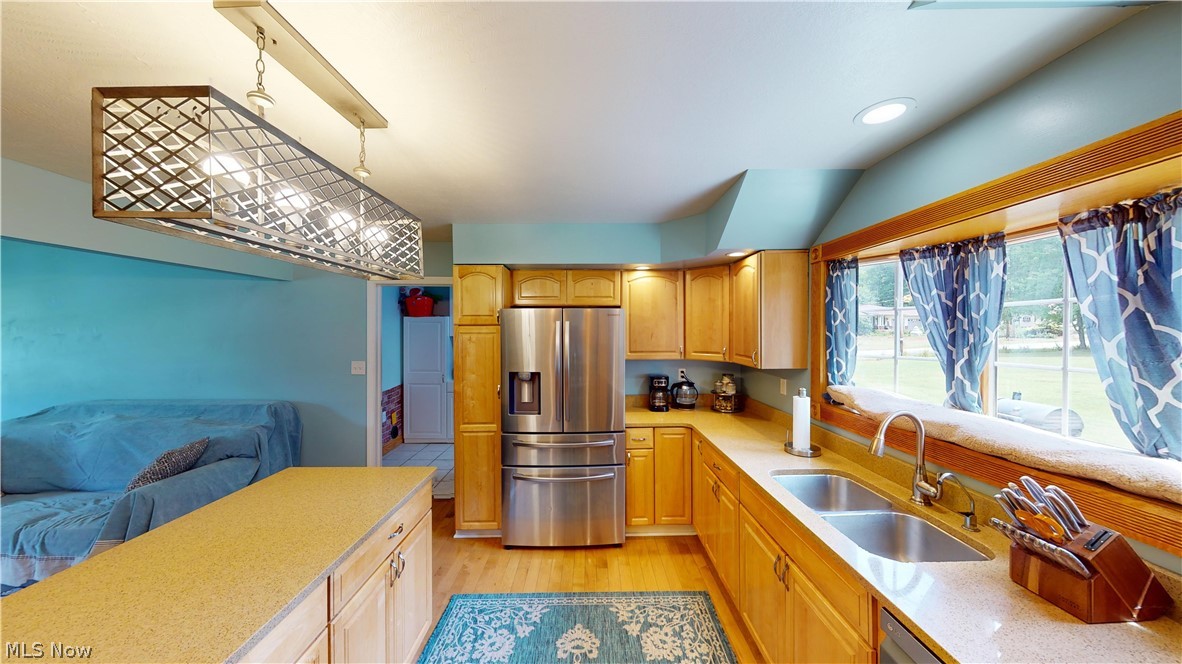 290 McIntosh Road Chester, WV 26034 - Photo 4 of 43 Kitchen with sink, stainless steel refrigerator with ice dispenser, lofted ceiling, and light wood-type flooring