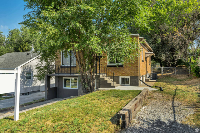 662 29th Street Ogden, UT 84403 - Photo 1 of 23 Two-story property featuring a brick exterior and a ground-level entrance with a balcony above
