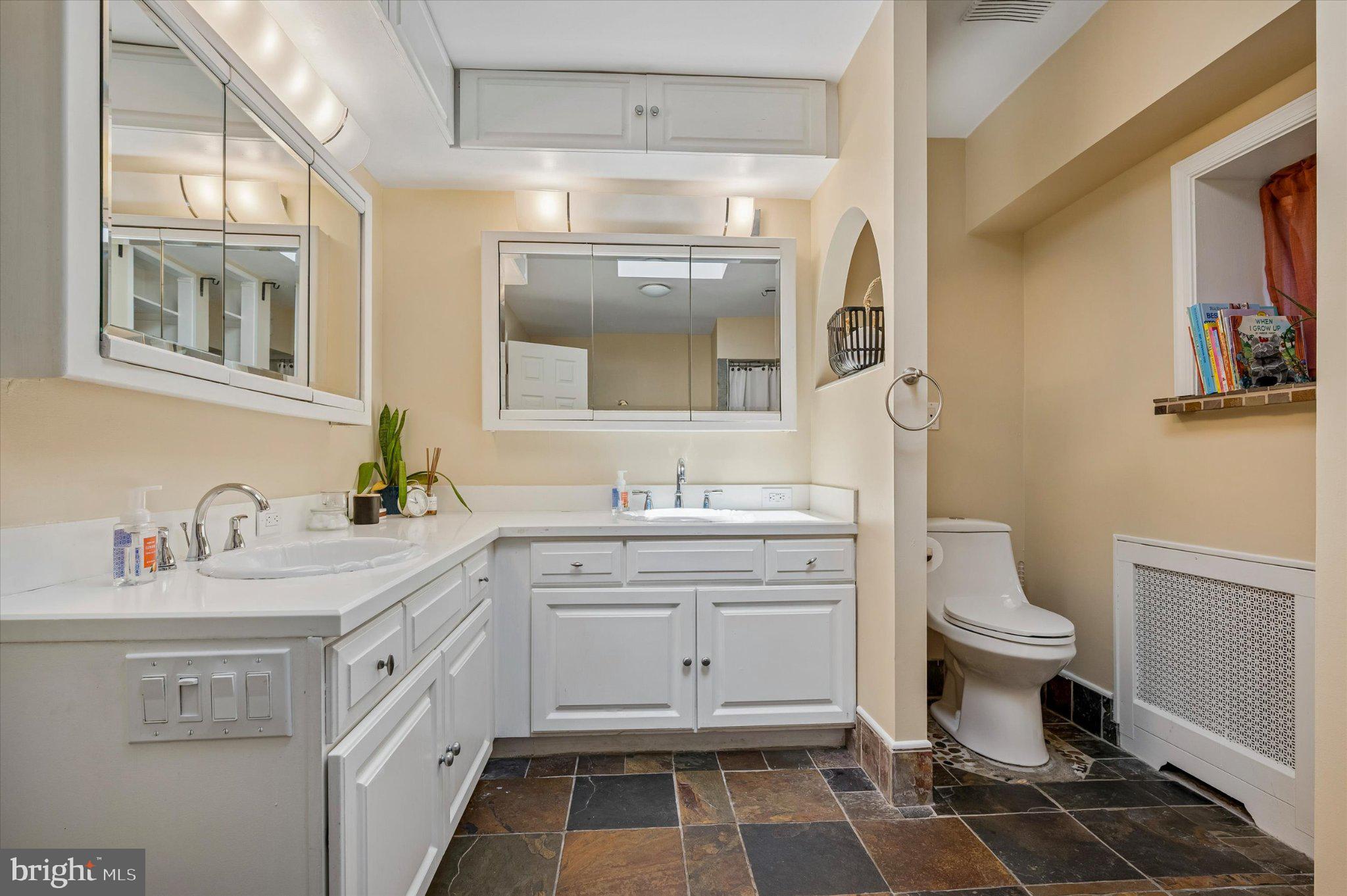2834 Edgemont Street Philadelphia, PA 19134 - Photo 16 of 37 a bathroom with a sink toilet and mirror