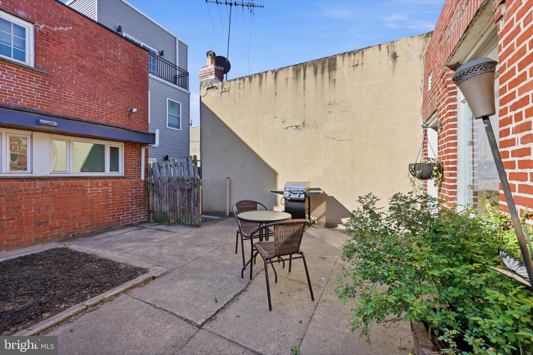 2834 Edgemont Street Philadelphia, PA 19134 - Photo 22 of 37 a view of a patio with a table and chairs and potted plants