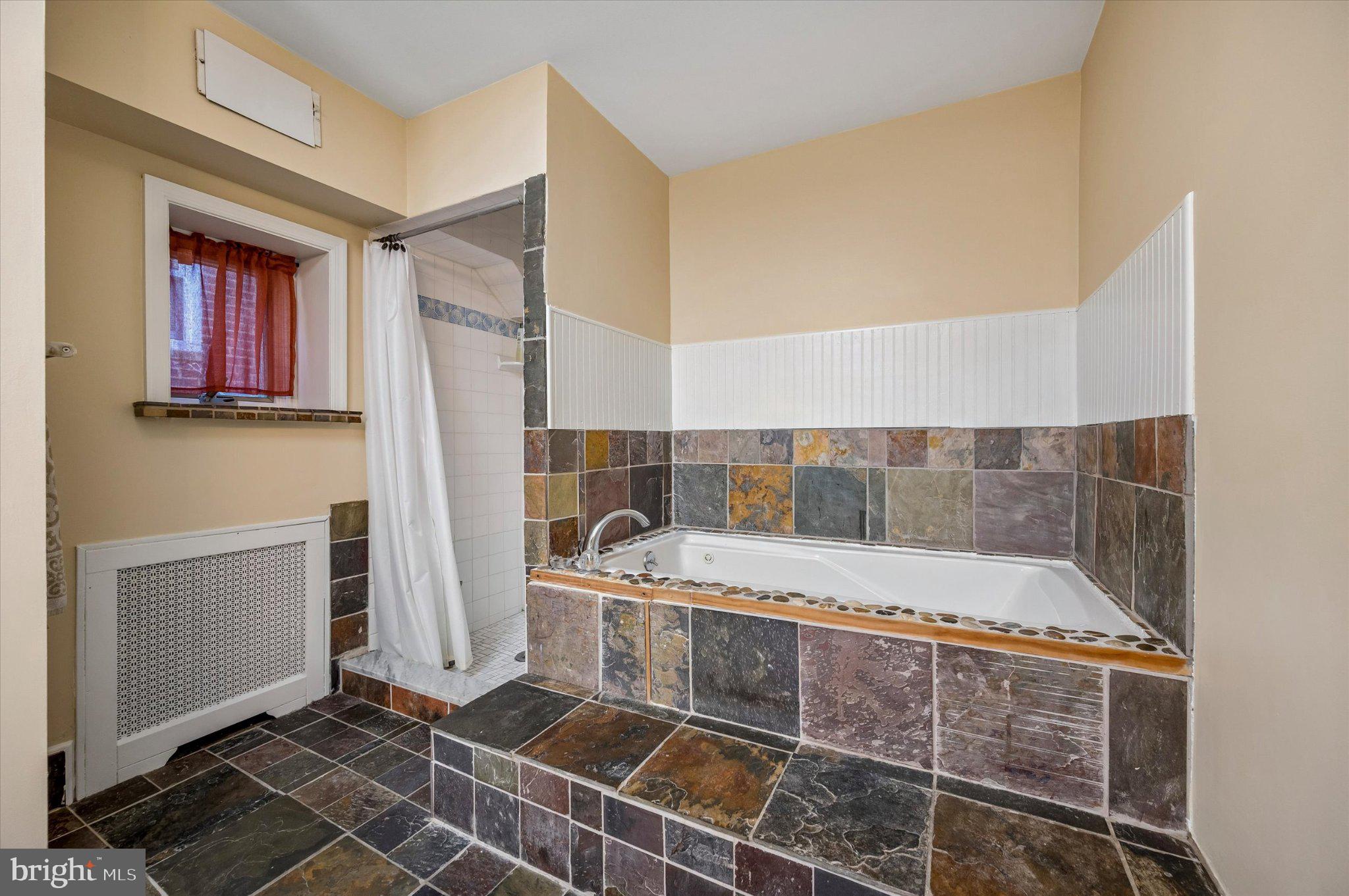 2834 Edgemont Street Philadelphia, PA 19134 - Photo 23 of 37 a bathroom with a bathtub and shower